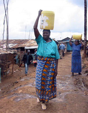 Woman carrying a water jug in Kenya
