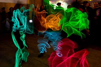 Three dancers perform Thai dance in Electroluminescent Wire costumes 