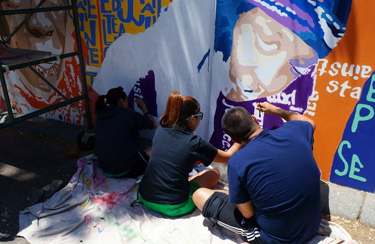 students painting mural 