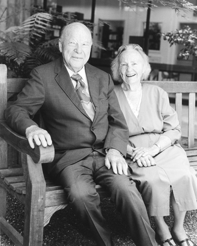 Photo of Dean and Jane McHenry, on bench in McHenry Library