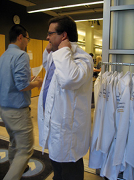 scott brandt gets fitted with a lab coat 
