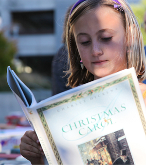 child reading Dickens' "Christmas Carol"