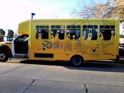 Campus shuttles wrapped with anniversary signs