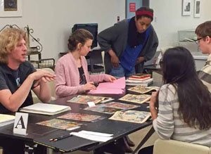 Undergraduate student curators selecting materials for the Marie Severin exhibit in the Sp