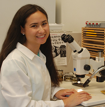 Karla Knudson at microscope