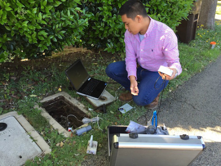 Joe Dizon installs a cellular beacon on a water meter. 