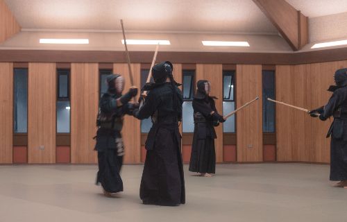 Members of the campus Kendo Club practice with their bamboo swords, called shinai. 