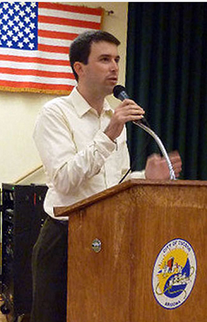 Photo of Gabe Zimmerman speaking at a podium
