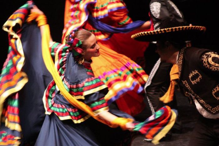 Photo of folklorico dancers performing in full costume.