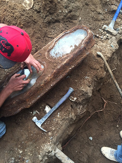 construction crew unearthing coffin