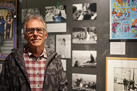 Alumnus Eric Thiermann in front of his photos of The Human Be-In, Golden Gate Park, Januar