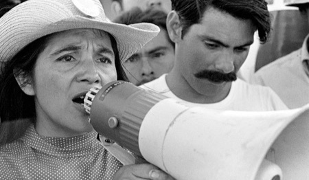 Archival photo of Dolores Huerta with a bullhorn