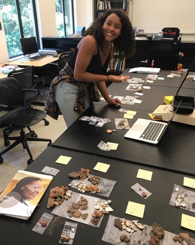 Photo of Jewell Humphrey in an anthropology lab with artifacts