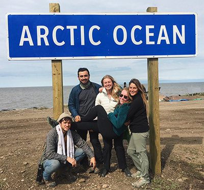 students pose with arctic ocean sign