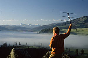 Photo of Chris Wilmers holding device used to track wolves in Yellowstone National Park