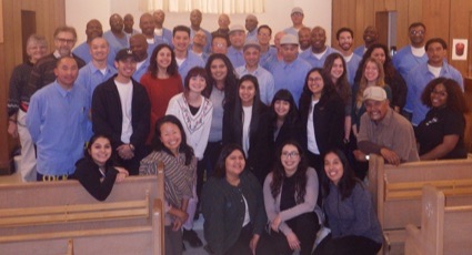Group photo of UCSC students and their Soledad counterparts in the prison chapel 