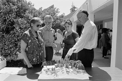 Edward Houghton showing an architectural model to Joyce Brodsky