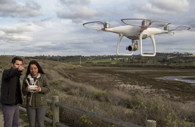 researchers flying a drone over a wetland
