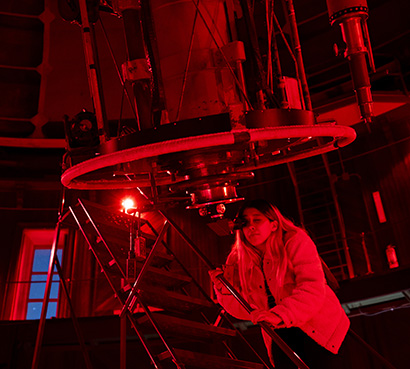 student looking through telescope
