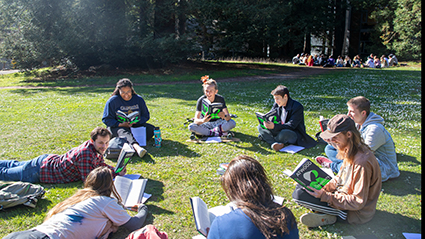 students in meadow reading
