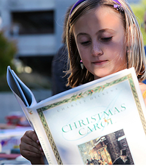 girl reading Dickens' A Christmas Carol