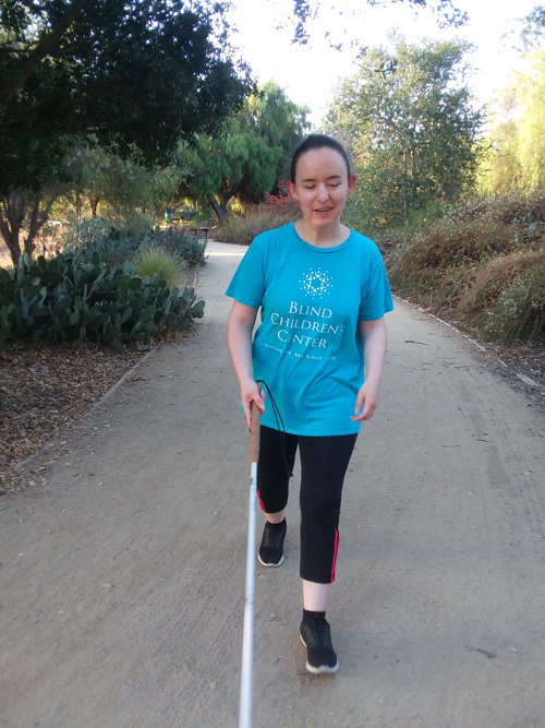 Karen Arcos walking with a cane 