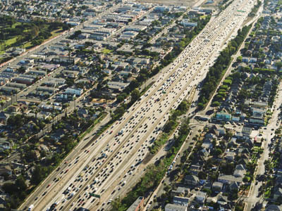overhead view of a highway with neighborhoods on both sides