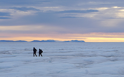 researchers on ice at sunset