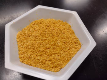A dish on a countertop holding thin yellow flakes