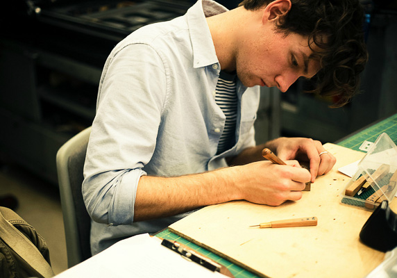 Student carving his work.