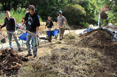 Students work the compost pile 