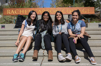 students with rachel carson college sign