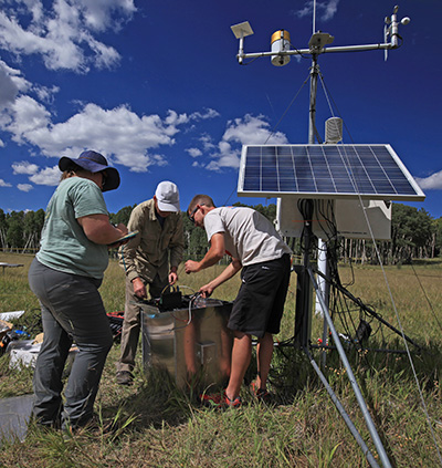 scientists setting up instruments in field