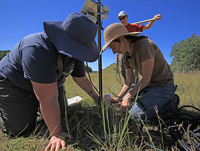 scientists setting up instruments in field