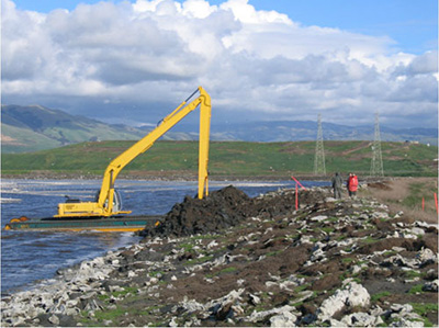 heavy equipment working on wetlands restoration project