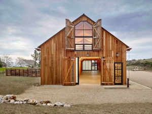 Photo of renovated Cowell Ranch Hay Barn lit up at night