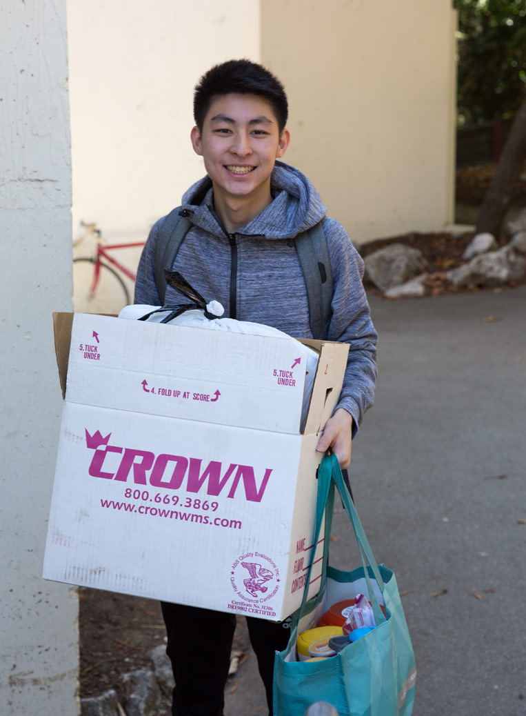 Student holding Crown moving box