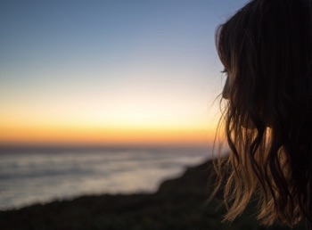 Silhouette of teen in profile at sunset