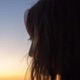 Silhouette of teen in profile at sunset