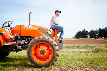 CASFS' apprentice sitting on a tractor