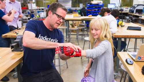 researcher with robotic glove