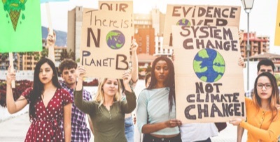 Photo of young climate justice protesters carrying signs