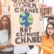 Girls hold climate change signs during a protest