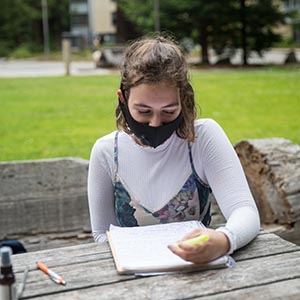 Student with mask on outside.