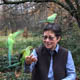 Anna Tsing in the forest with parrots landing on her arms.