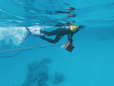 diver with underwater speaker
