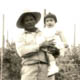 Leon Deocampo holding his baby niece in front of a sugar pea field circa 1959.