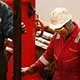 worker with drilling rig