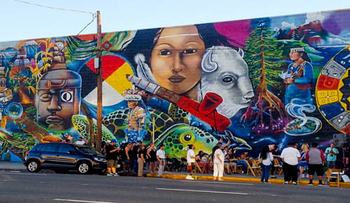 community members gathered near a mural in Los Angeles