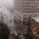 Rain on apartment window looking down on city street